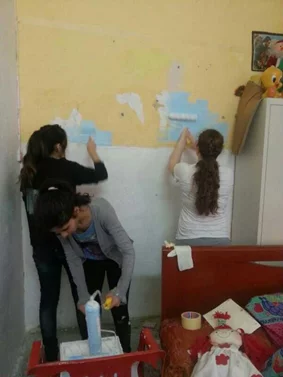 Jamhour students painting a House